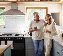 Couple standing in kitchen