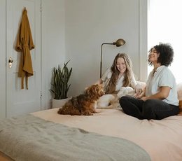 Two friends relaxing on a bed