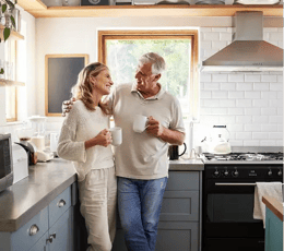 Couple enjoying their kitchen together