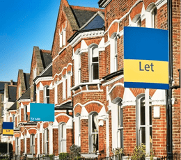 Terraced houses with estate agent signs