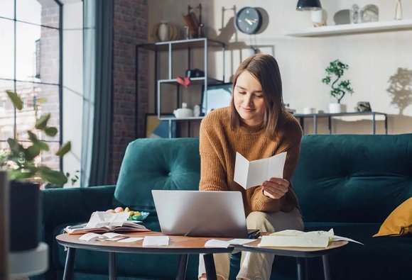 Woman reviewing mortgage documents at home