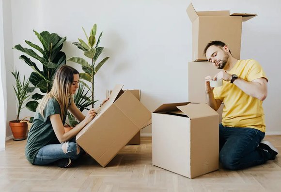 Couple unpacking boxes in their new home